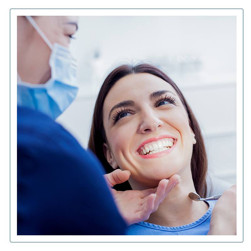 dentist examines woman's teeth