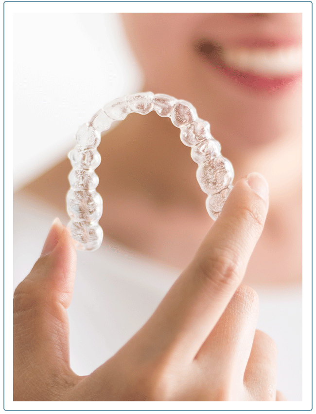 woman holding her next Invisalign tray