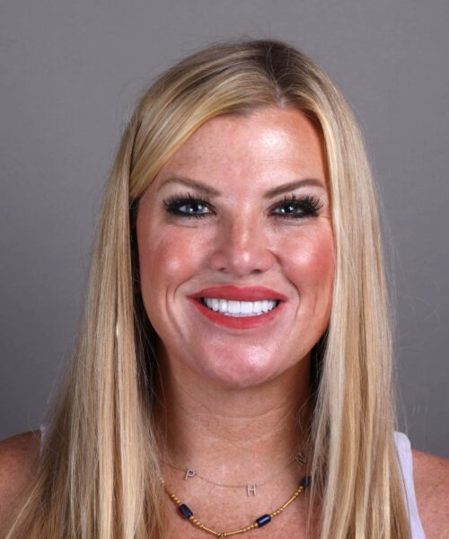 a close up of a woman who is smiling at the camera