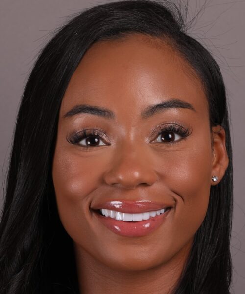 a close up of a woman who is smiling at the camera