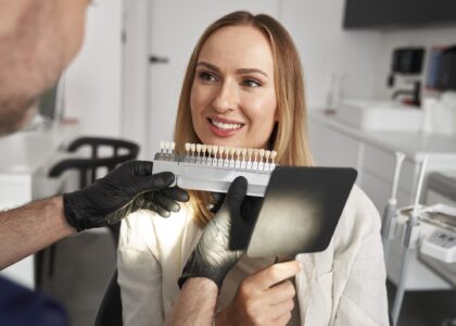 A woman visits Koch Aesthetic Dentistry for a consultation to determine whether professional teeth whitening or porcelain veneers are right for her aesthetic needs.