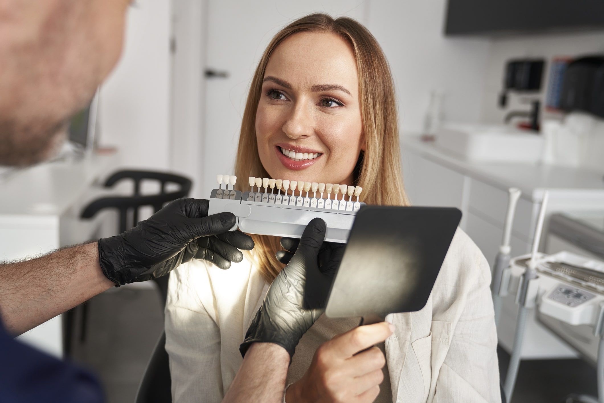 A woman visits Koch Aesthetic Dentistry for a consultation to determine whether professional teeth whitening or porcelain veneers are right for her aesthetic needs.